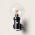 Applique murale cylindrique noire en métal, globe verre transparent, détecteur PIR visible