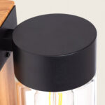 Applique murale cylindrique noire, capot métal et verre transparent montrant ampoule à filament, fixation murale