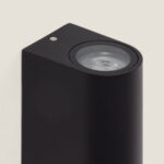 Applique murale noire finition mate, corps rectangulaire arrondi avec optique ronde encastrée orientée vers le haut