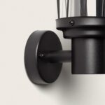 Applique murale extérieure noire en aluminium mat, corps cylindrique avec grille verticale et fixation murale ronde