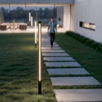 Balise extérieure LED noire cylindrique, éclairage linéaire chaud, fixée au sol le long d'une allée