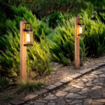 Balise sur pied en aluminium brun clair avec lanterne cylindrique et fixation au sol