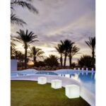 Lampe cube LED extérieure blanche posée près d'une piscine