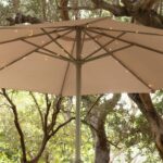 Guirlande LED blanc chaud fixée sous parasol beige le long des baleines