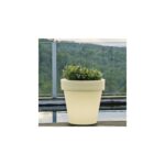Jardinière beige crème en résine, forme conique, contenant petit buisson vert, posée sur balcon