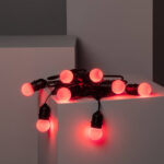 Guirlande lumineuse noire à ampoules rondes rouges, câble visible