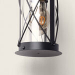 Applique murale extérieure en verre transparent avec cage métal noire et base finition mate, ampoule filament visible
