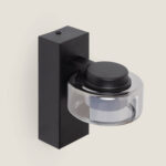 Applique murale noire en métal avec diffuseur cylindrique en verre transparent et support mural rectangulaire