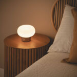 Lampe à poser ronde à abat-jour blanc cannelé sur socle foncé