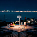 Lampe à poser blanche LED sur table extérieure, design cylindrique, éclairage d'ambiance chaleureux