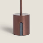 Lampe à poser métallique bronze, socle cylindrique mat avec tige verticale et cache plastique