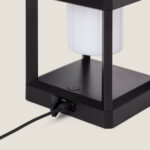 Lampe à poser solaire noire, cadre rectangulaire, diffuseur cylindrique blanc, base avec port de charge et câble