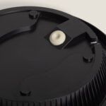 Plafonnier rond noir, vue de la base de fixation avec joint blanc et bord extérieur rainuré