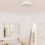 Plafonnier rond blanc à montage apparent au plafond, design épuré et profil bas