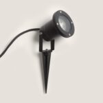 Spot extérieur sur piquet noir orientable, corps cylindrique avec vitre frontale et câble d'alimentation