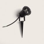 Spot extérieur noir sur piquet orientable, corps cylindrique métallique, grille avant et câble d'alimentation visible