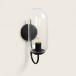 Applique murale en métal noir avec abat-jour cylindrique en verre transparent et socle pour ampoule visible