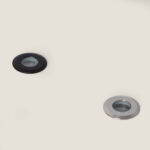 Spot encastrable au sol rond noir et argenté avec lentille centrale